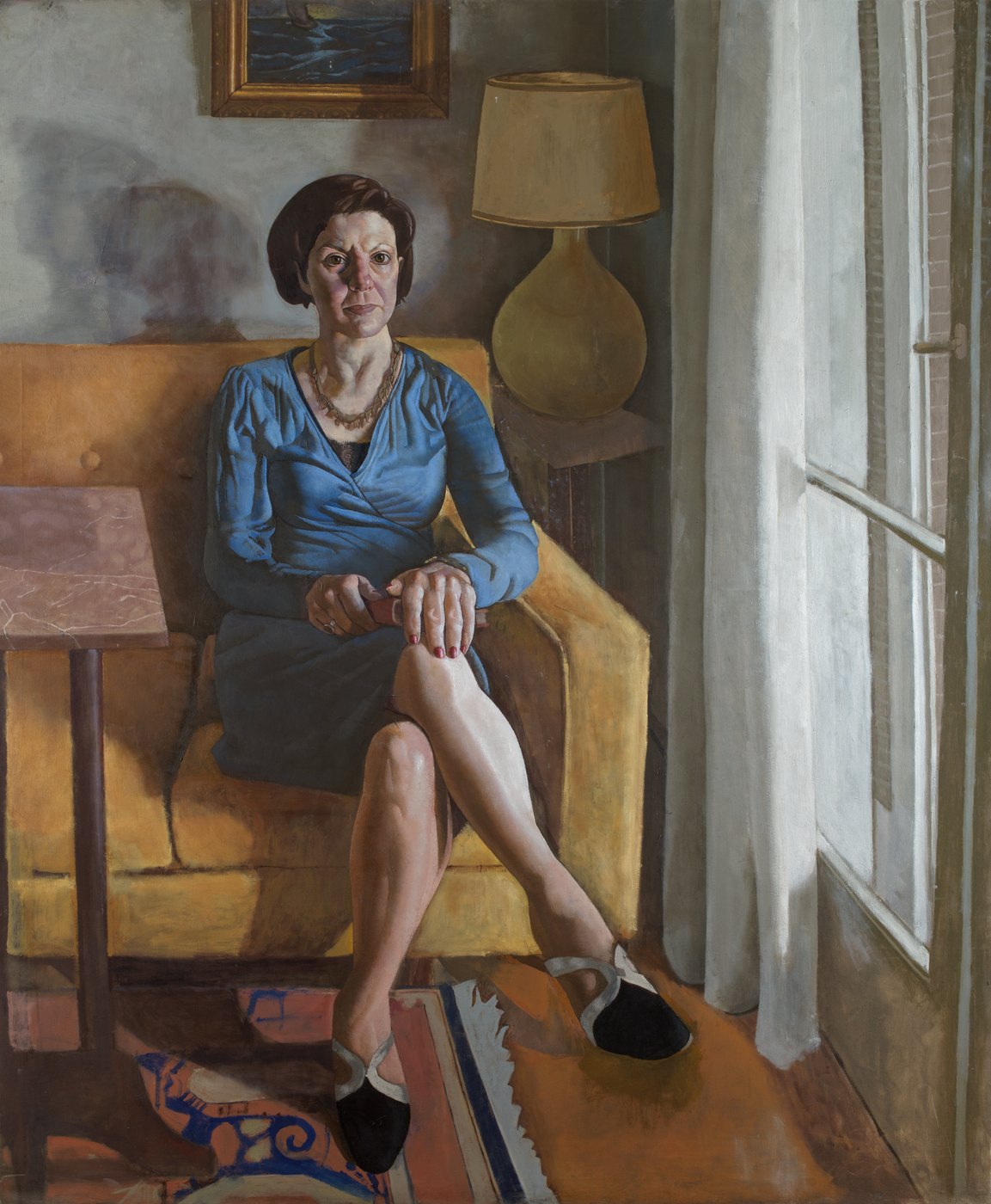 Aris Mertilis, The Pause (Η παύση), oil on canvas. Woman in a blue blouse on an ochre sofa, table lamp and curtained window.