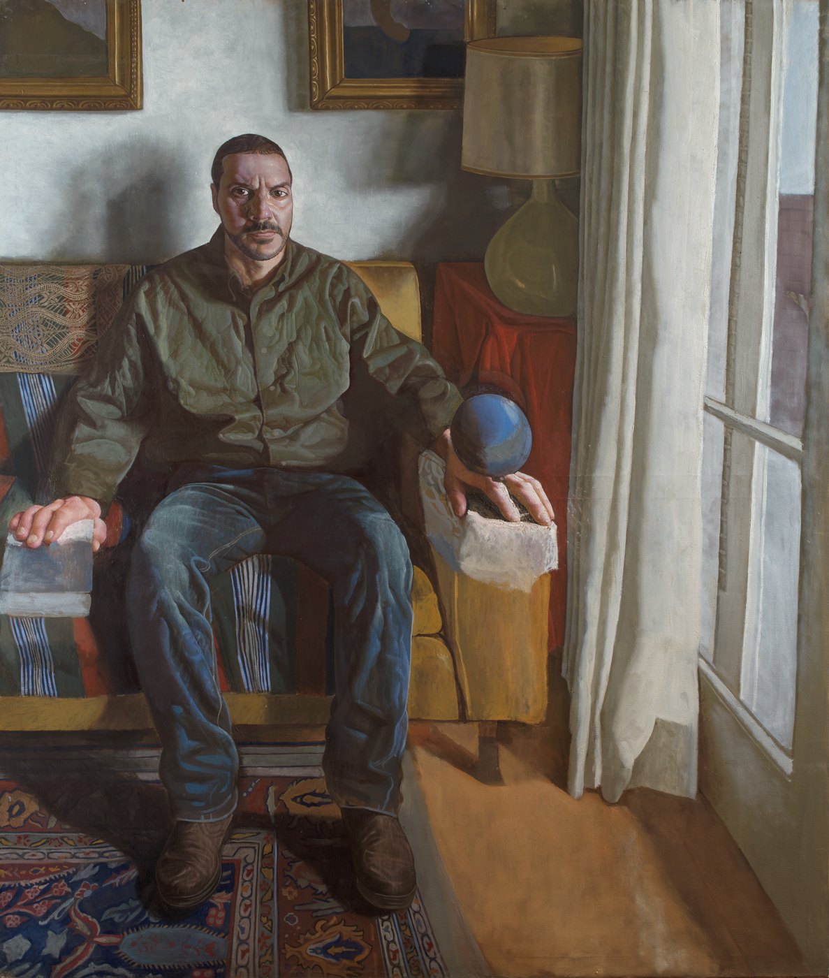 Aris Mertilis, Weight (Βάρος), oil on canvas. Man in an olive shirt on a sofa, holding a blue sphere.